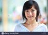 portrait-of-one-young-asian-woman-smile-at-camera-KAWFG8.jpg