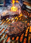 bone-in-ribeye-over-hot-coals-on-grill.jpg