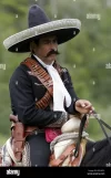 a-mexican-cowboy-on-horseback-B2NWT6.webp