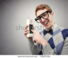 stock-photo-nerd-student-with-an-old-mobile-phone-136078364.jpg