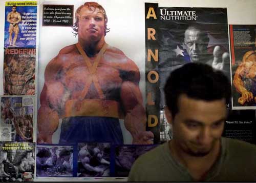 Posters of Arnold Schwarzenegger and other famous body builders cover the walls for inspiration. Photo credit: Andrea Bruce-The Washington Post