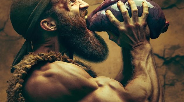 Muscular bodybuilder eating liver